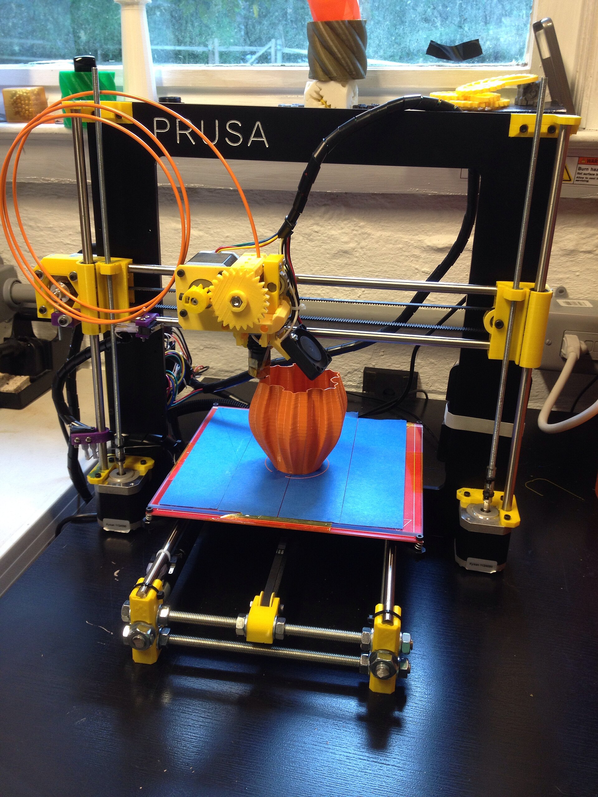 A desktop printer in the middle of a build