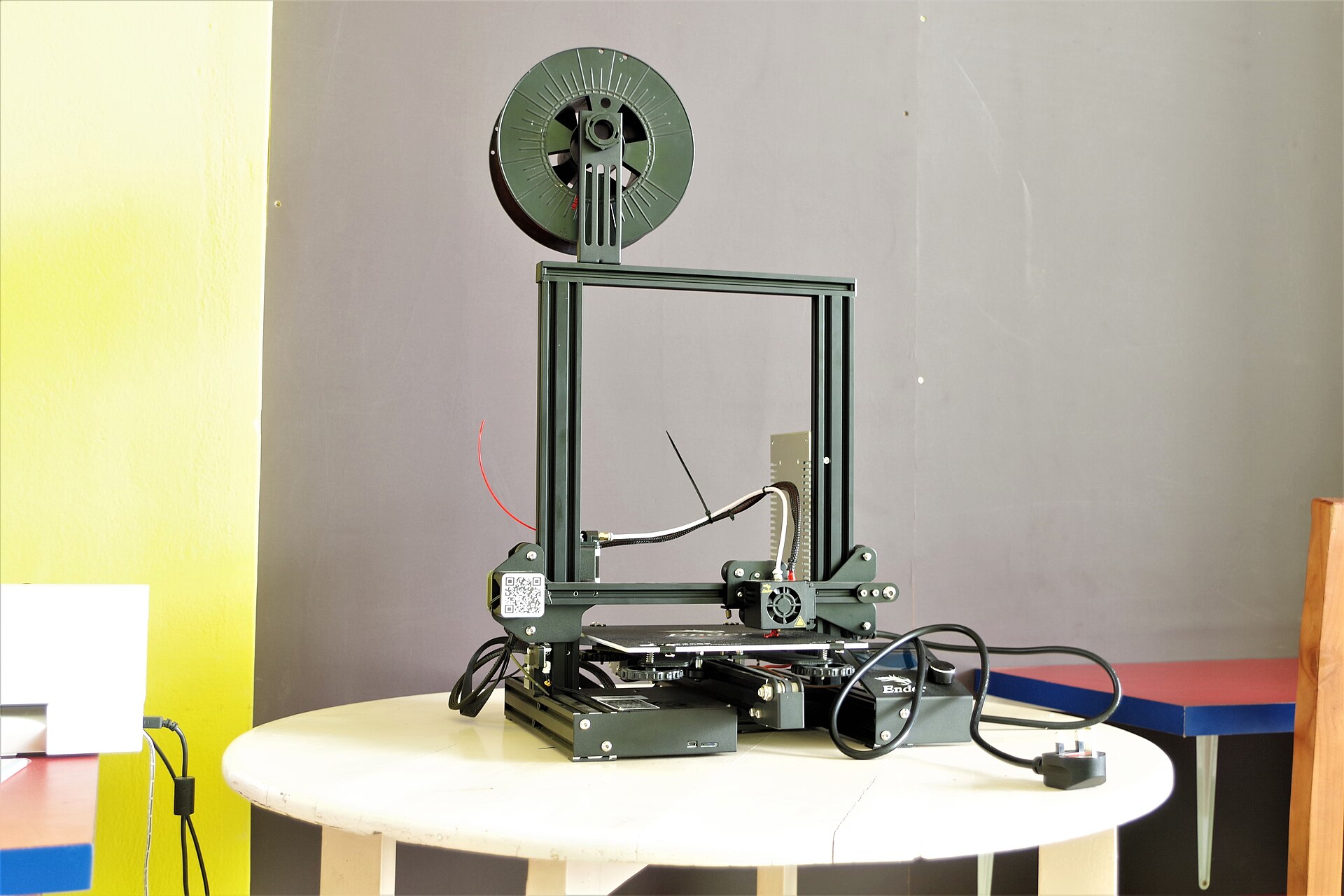 A large enclosed printer in a workshop