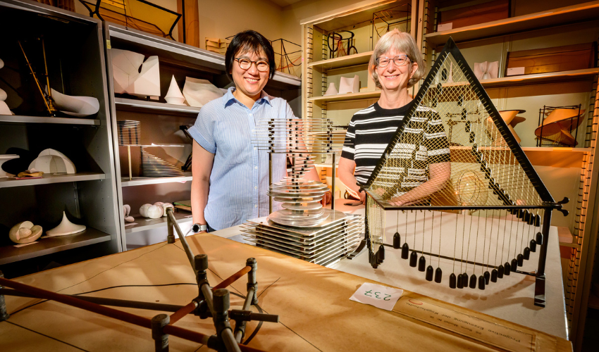 Photo of mathematics librarian Sarah Park and director of the Illinois Mathematics Lab Karen Mortensen with various 3D models.