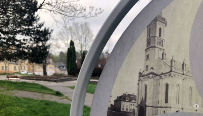 An informational sign indicates where the original church stood until 1976. (Credit: David Pluhař)