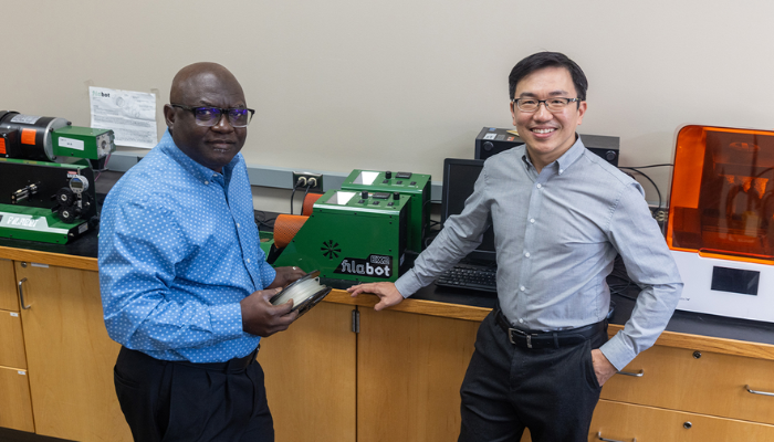 Dr. John Obielodan (left) and Dr. Joseph Wu (right) stand in their lab after announcing the new patented material. (Photo Credit: University of Wisconsin-Platteville)