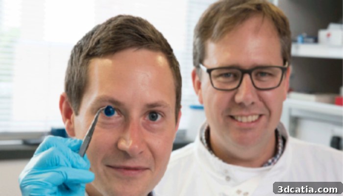 Two researchers from Newcastle University, Che Connon and another colleague, standing in a lab, discussing the 3D printed cornea research.