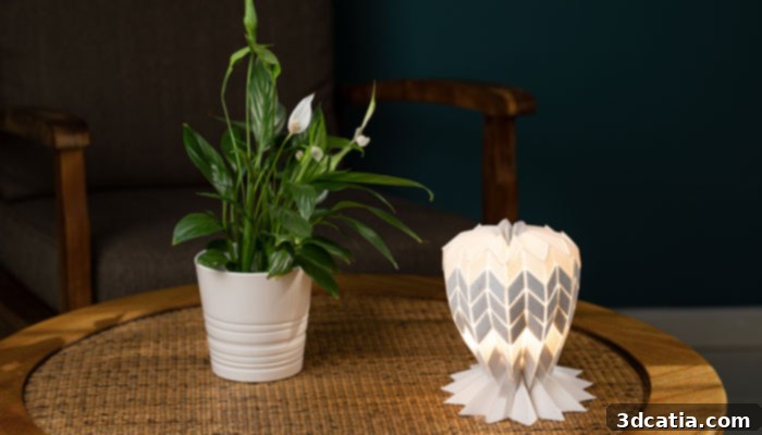 A close-up of a Conductive Origami lamp, revealing a patterned inner layer when lit.