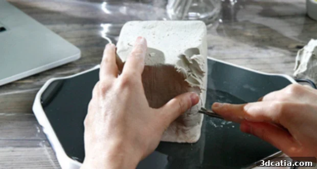 Chizzle: The New 3D Scan-to-Model Surface 3 A user interacting with the Chizzle smart sculpting surface and screen guidance