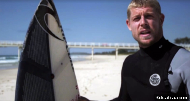 Mick Fanning holding the revolutionary 3D printed surfboard.