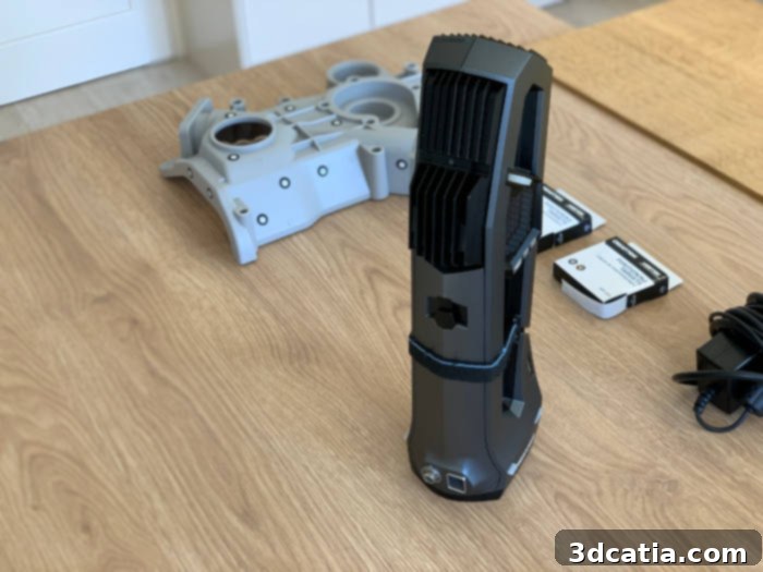 The Creaform Go!SCAN 3D, specifically designed for ease of handling and secured with a convenient hand strap for comfortable, extended use in professional scanning environments.