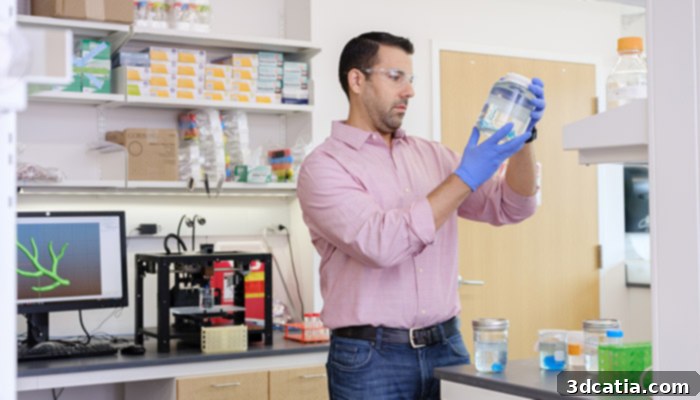 Adam Feinberg, biomedical engineer, with 3D printing equipment