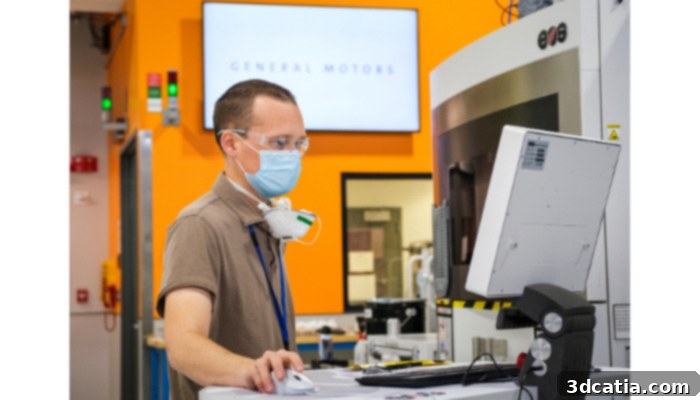 Engineer examining a 3D printer at GM’s Additive Industrialization Center