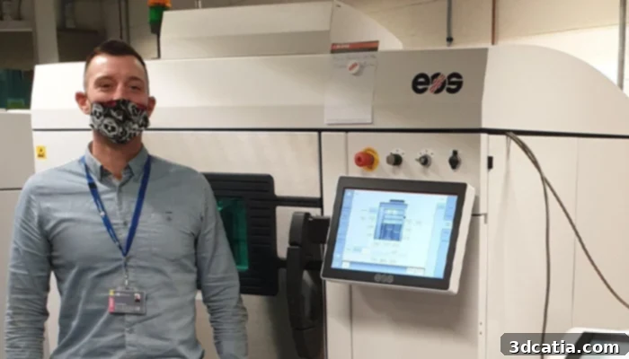 John Robinson and the 3D printer used to design the antiviral material