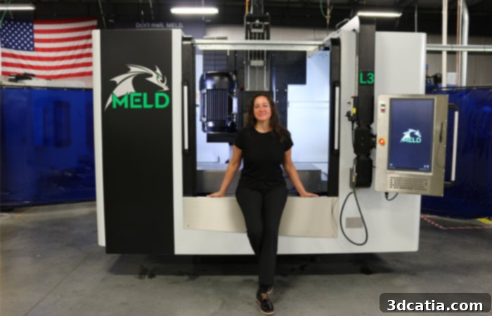 Nanci Hardwick in front of a MELD metal 3D printer, highlighting the technology's innovative approach to additive manufacturing.