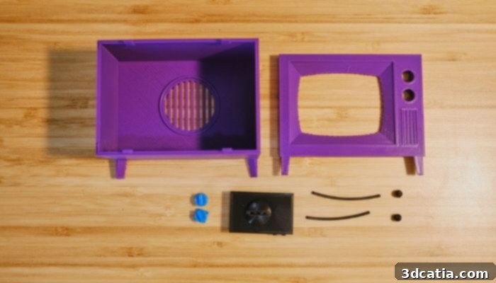 A fully assembled 3D printed mini TV, playing an episode of The Simpsons, showcasing its retro design and vibrant display.