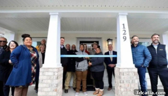 April and her family standing in front of their new 3D printed home from Habitat for Humanity.