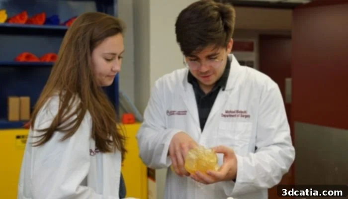 Two students examine a replica of a heart made using Stratasys’ 3D technology