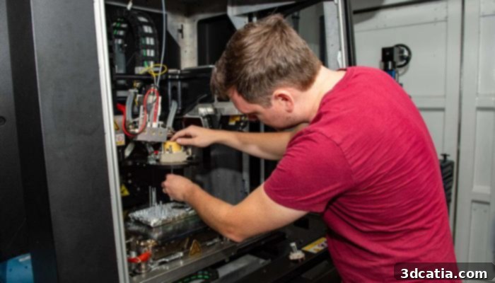 Xerox technician assembling 3D printer head aboard USS Essex