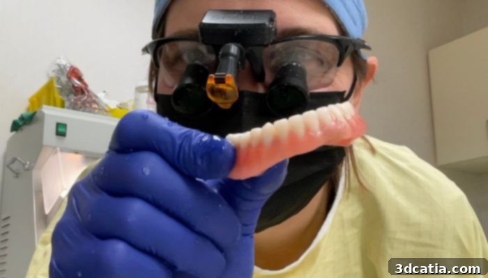 A prosthodontist who uses 3D printing demonstrates a full 3D printed denture.