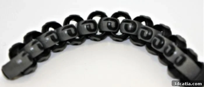 Evolve's STEP technology demonstrated by a co-printed chain in black and gray ABS.