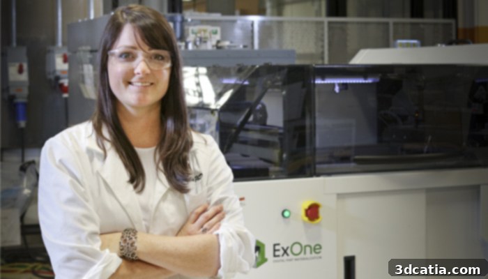 Amy Elliott next to an industrial 3D printer at ORNL