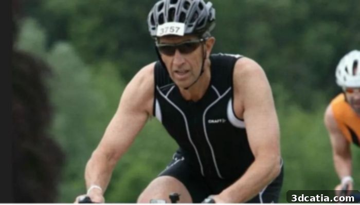 Dave Richards is passionate about biking, smiling next to his bicycle.